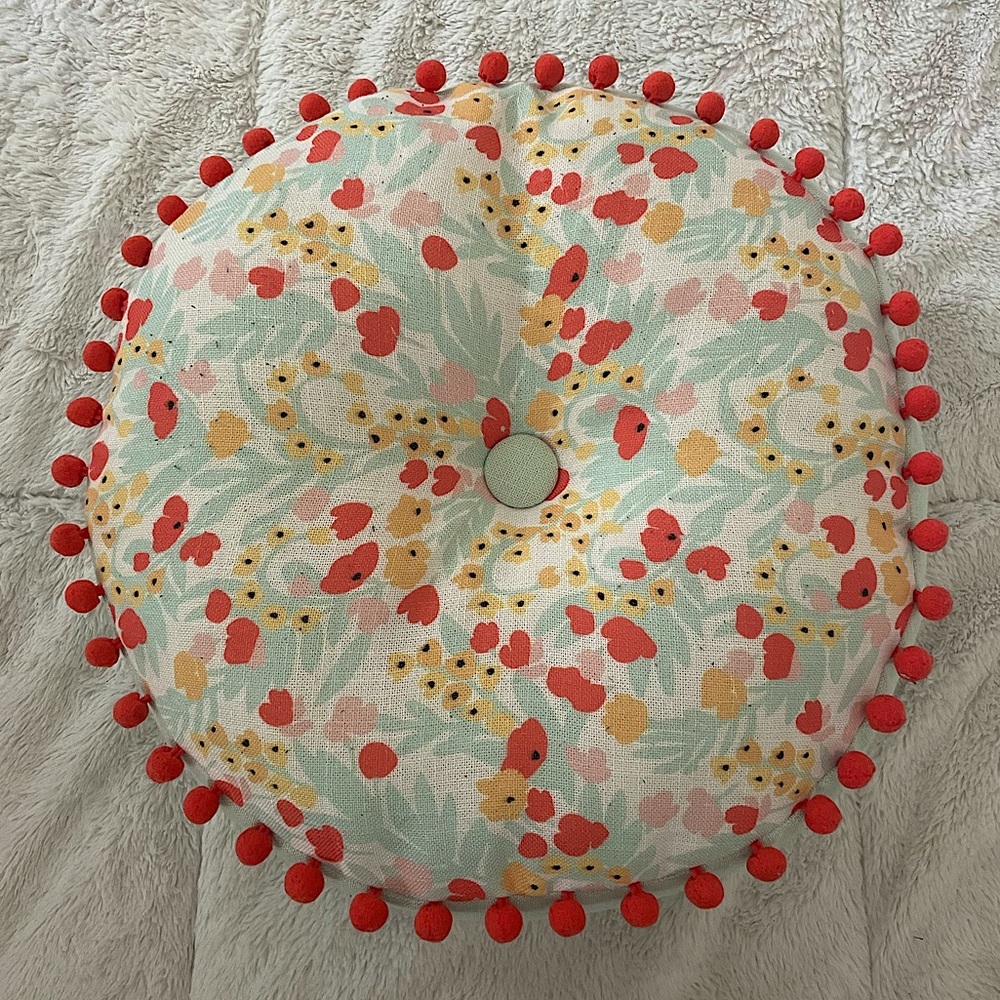 Round Floral Throw Pillow with Red Pom-Poms